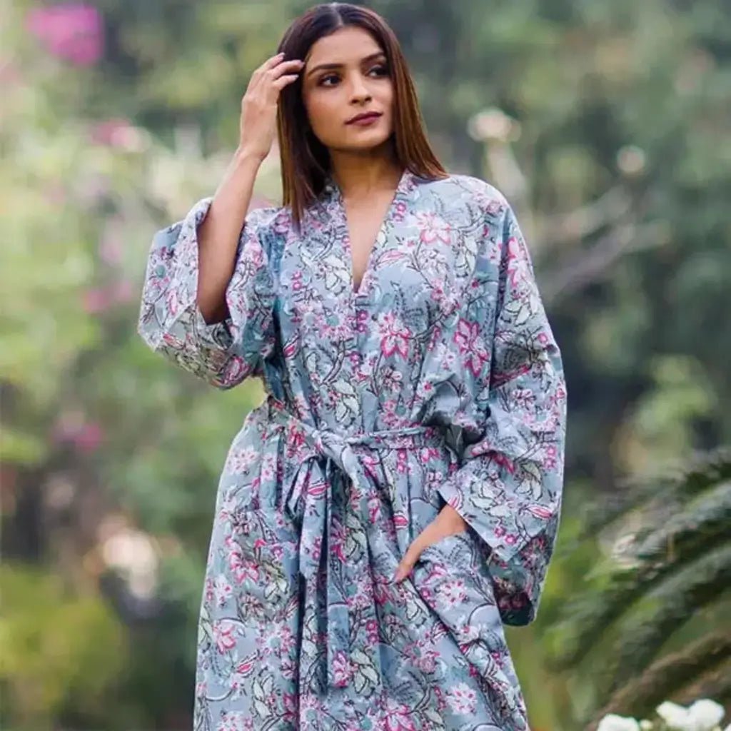 a woman wearing a long grey floral print robe from sevya handmade