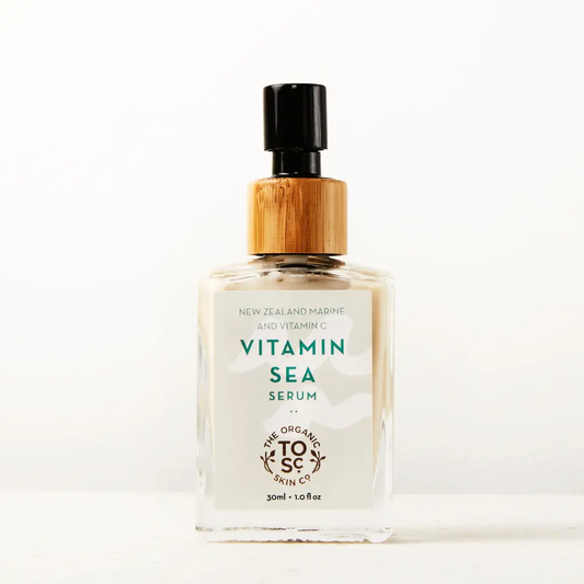 a bottle of vitamin sea face serum sitting on a table
