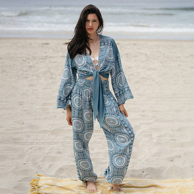 Sapphire Beach Daydreamer Bell Sleeve Top with tie-front design and boho print, styled as a beach cover-up over a bikini. Flowy bell sleeves add a relaxed, bohemian vibe.