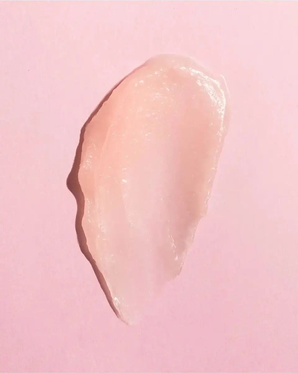 Close-up of Earth Harbor SEA KISS lip balm swatch, showcasing its smooth, glossy texture and sheer pink tint for hydration and plumping.