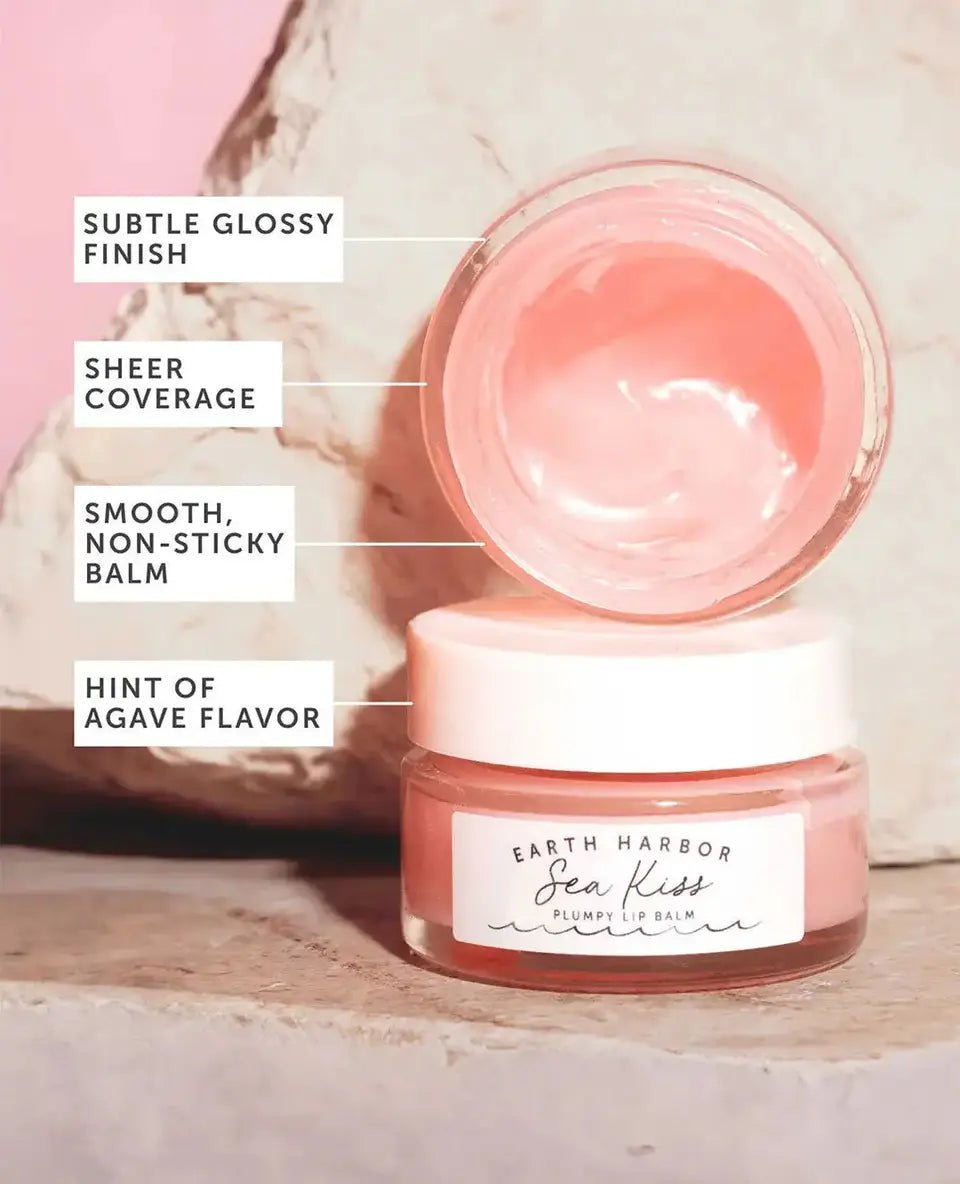 Earth Harbor SEA KISS lip balm open jar with text highlighting its subtle glossy finish, sheer coverage, smooth texture, and hint of agave flavor.