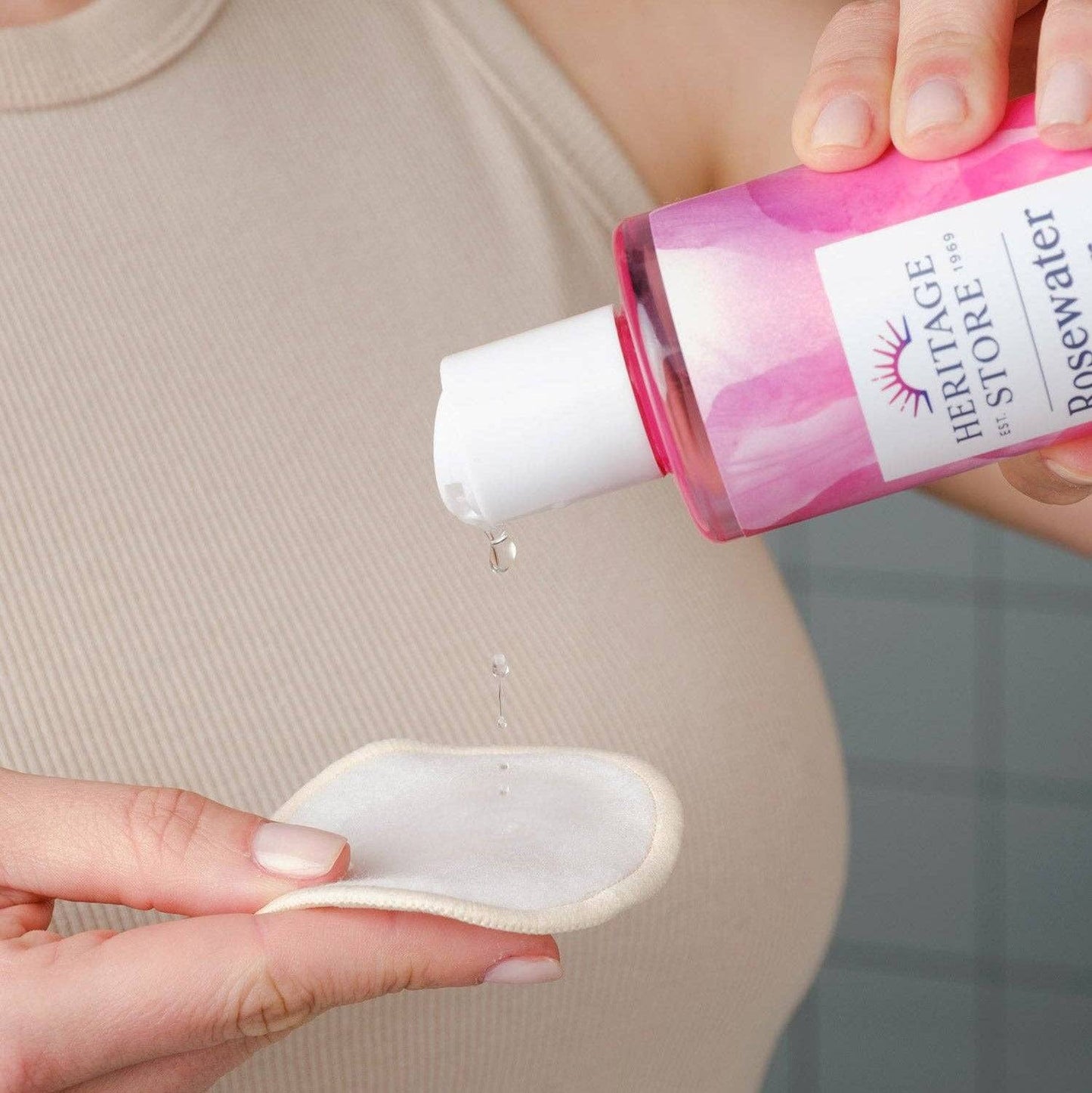 Heritage Store Rosewater Toner Mini being poured onto a cotton pad, ideal for hydrating and refreshing skin. Buy Rosewater Toner for glowing skin.