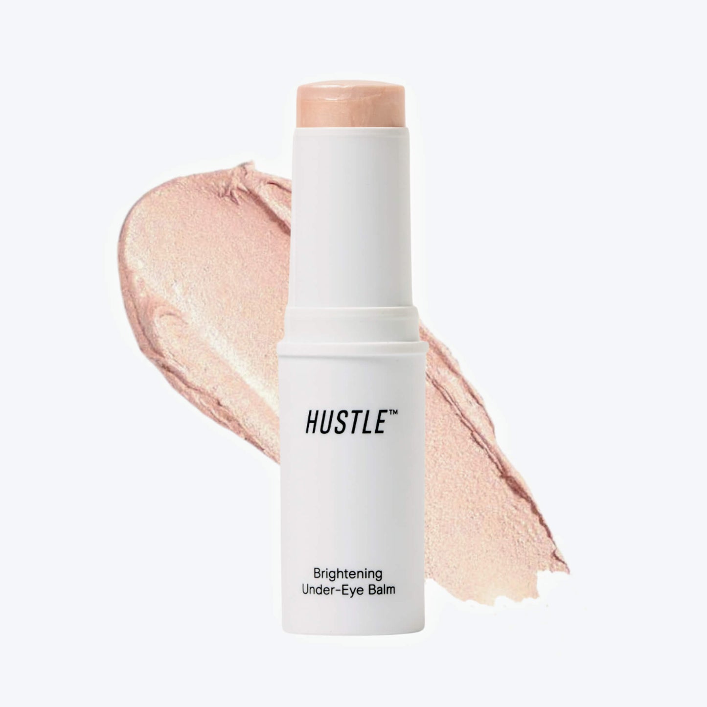 Hustle brightening under-eye balm with a swatch of product color on a light background