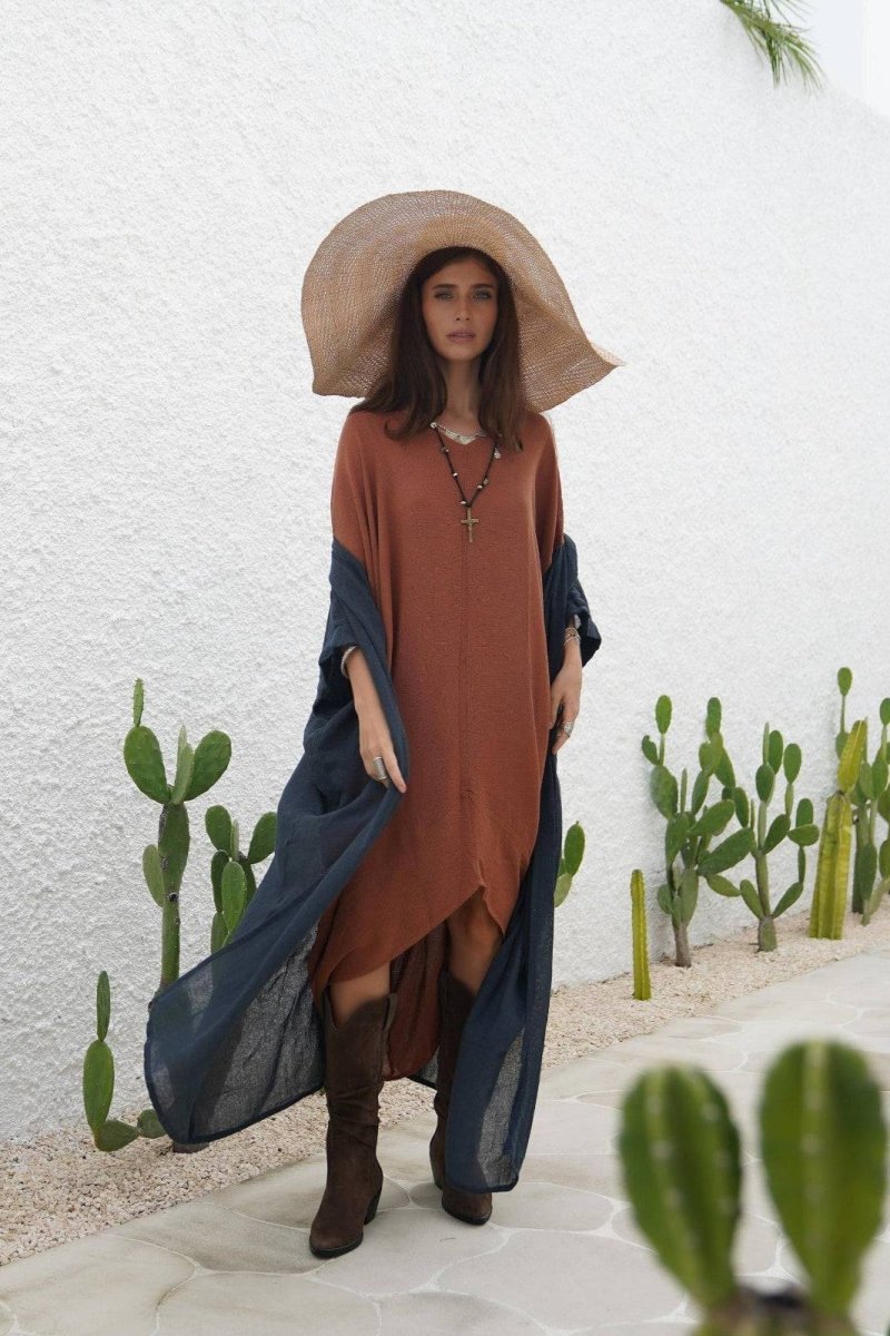 Indigo Blue Long Kimono Duster in lightweight ramie cotton draped over a rust dress, styled with a wide sun hat and boots for a boho-chic look. Ideal for layering in warm weather with breathable three-quarter sleeves and included macrame belt.