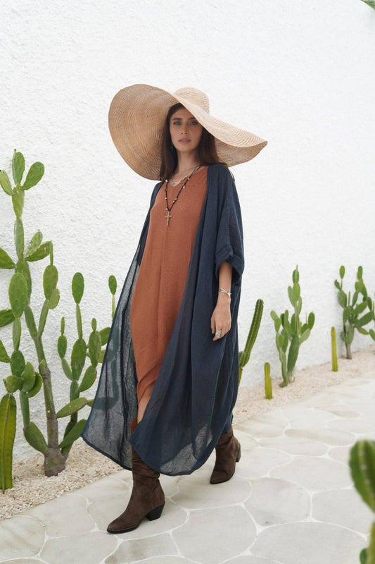 Indigo Blue Long Kimono Duster in lightweight ramie cotton layered over a rust dress, styled with a wide-brim hat and boots for a boho-chic look.
