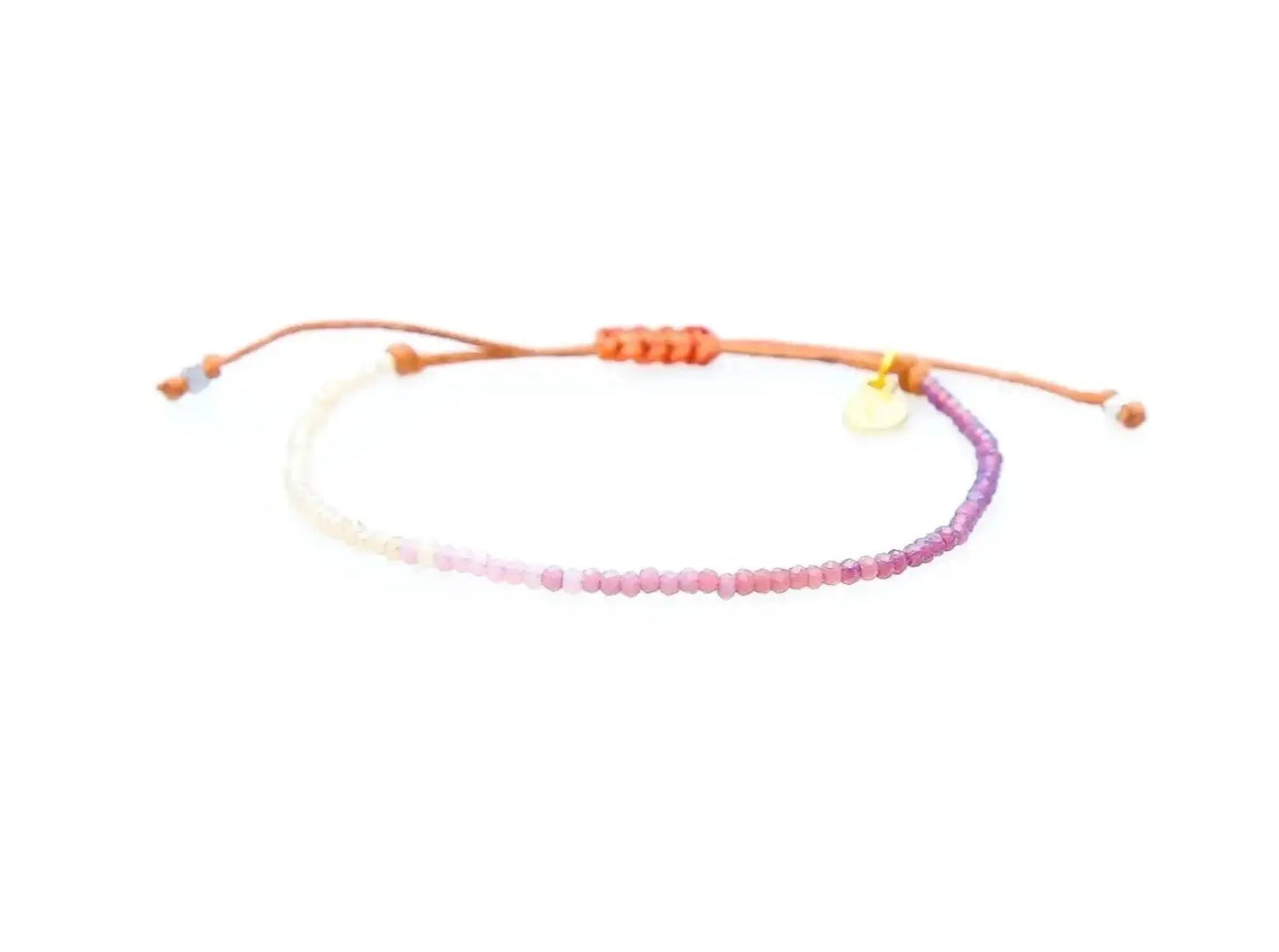 Lotus and Luna Stay Wild Moon Child Bracelet. Pink and purple seed beads on an adjustable cotton cord with coconut button closure.