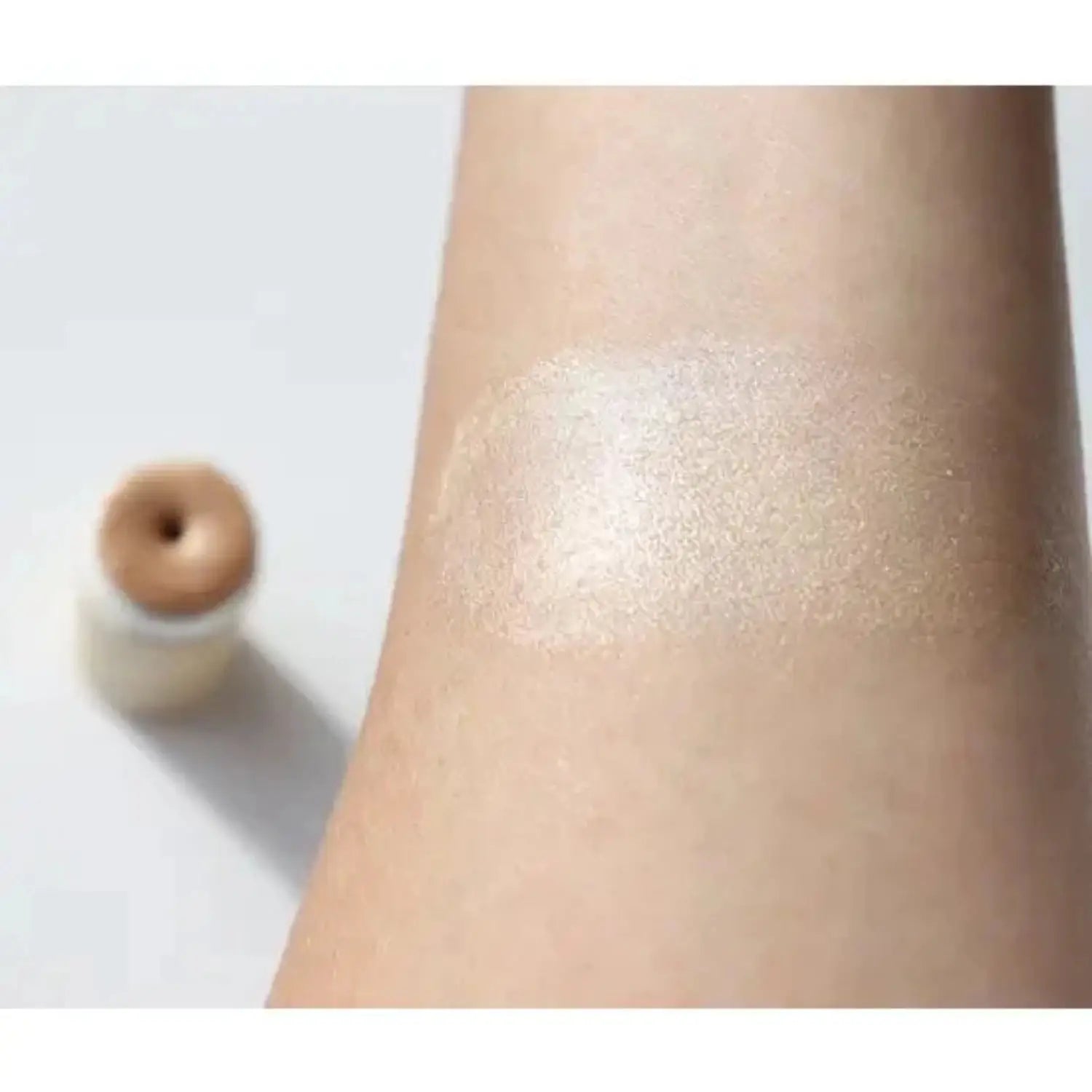 River Organics illumi Face Highlighter Stick Shown on Skin| Sustainable Packaging | Vegan Ingredients