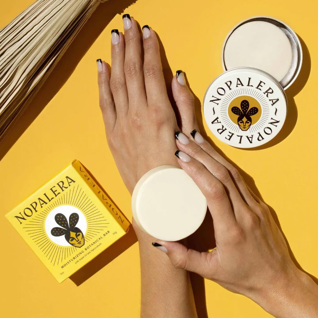 a hand holding a nopalera lotion bar
