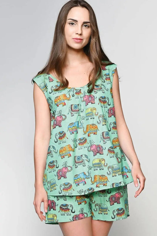 a woman wearing a green top with elephants on it
