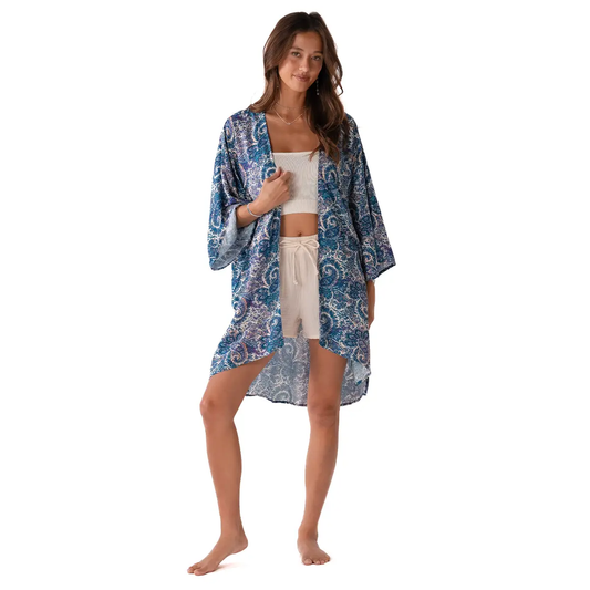 Lotus and Luna Beach Cover in blue paisley print, lightweight handmade swim wrap with side slits, styled as a boho kimono over beachwear.