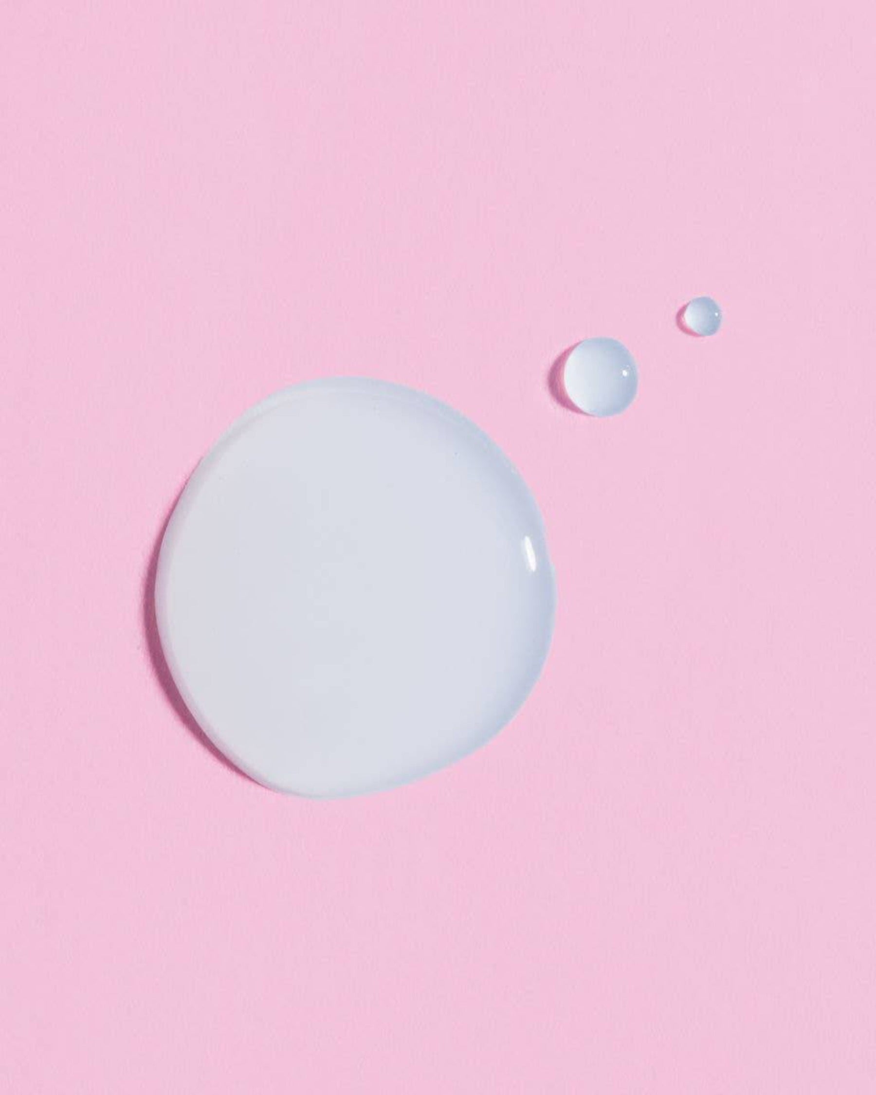 a pink background with two drops of earth harbor luna rain night serum
