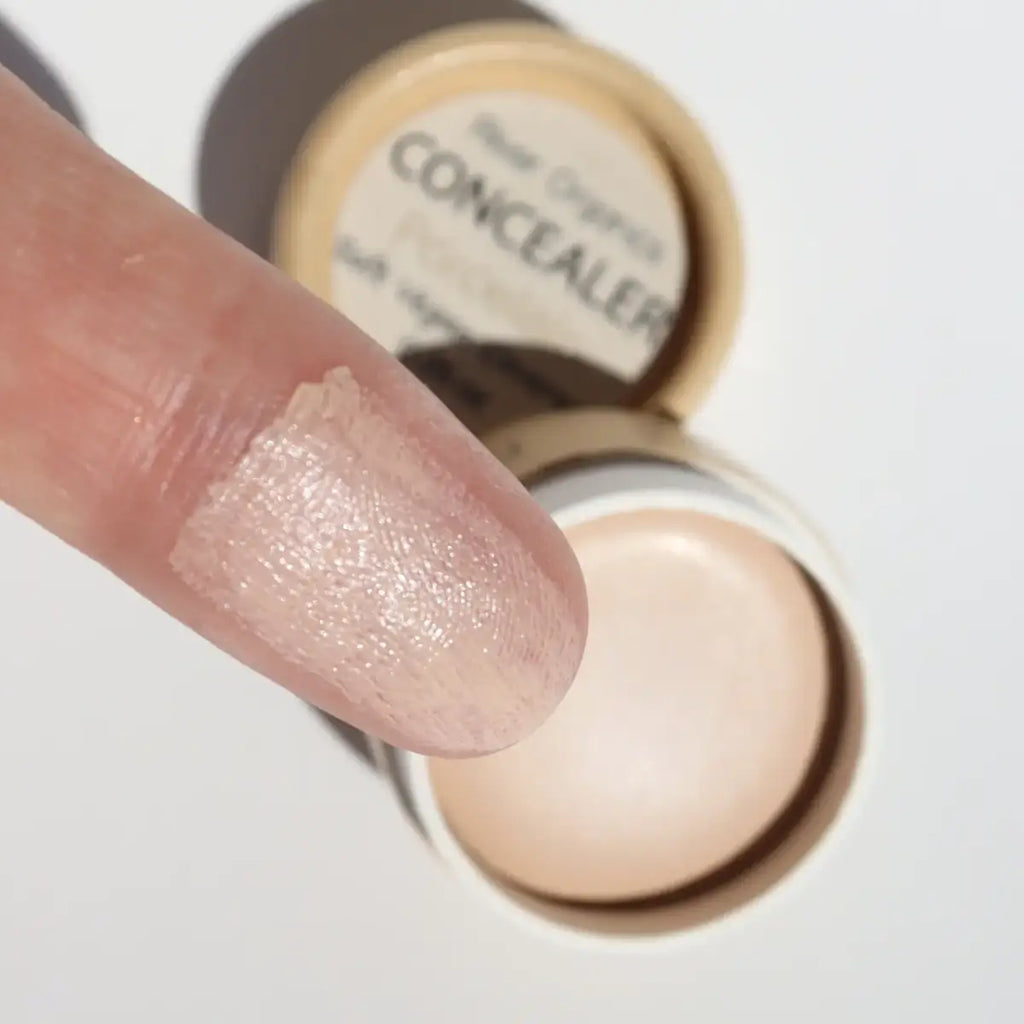 Organic natural vegan cream concealer in a small eco-friendly pot with light beige tone, ideal for dark under eyes and blemishes on sensitive skin.