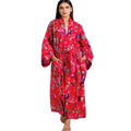 woman wearing the birds of paradise floral cotton red kimono robe by sevya handmade with long sleeves, pockets, maxi length