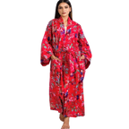 woman wearing the birds of paradise floral cotton red kimono robe by sevya handmade with long sleeves, pockets, maxi length