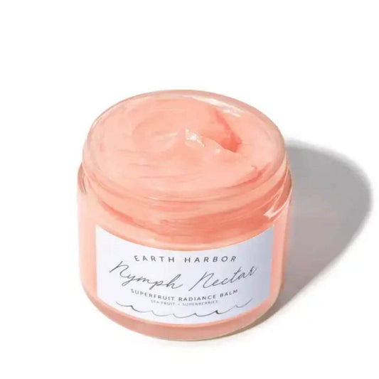 a jar of earth harbor brand bright pink cream on a white background