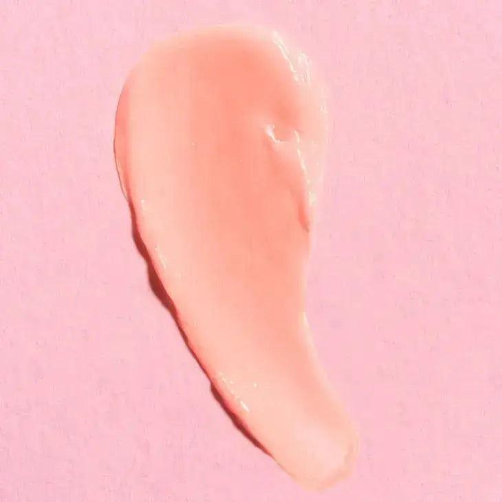 a close up of a pink lip mask on a pink background