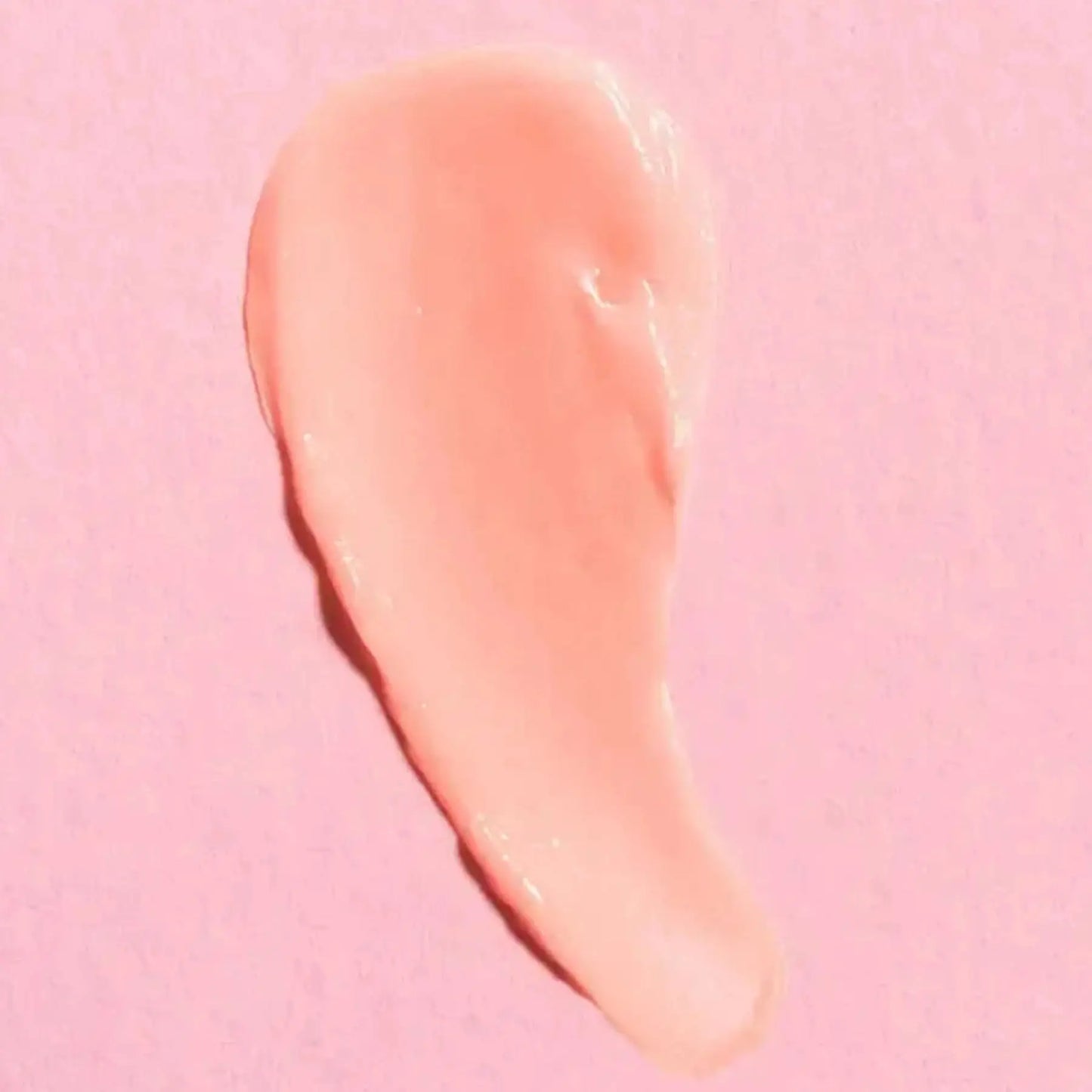 a close up of a pink lip mask on a pink background