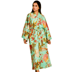 Woman wearing a light green floral kimono-style robe on a white background