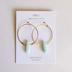 Gold hoop earrings with amazonite stones on a JaxKelly branded card.