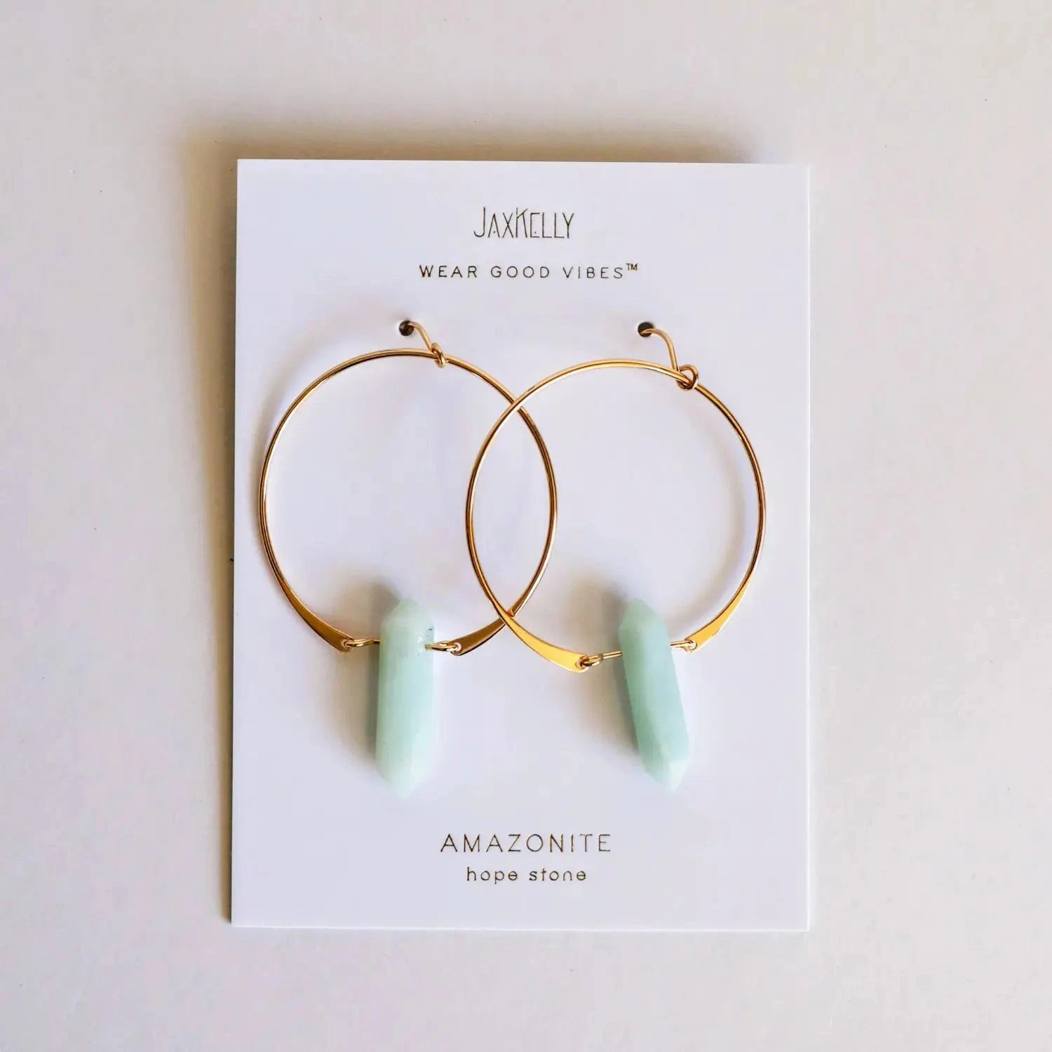 Gold hoop earrings with amazonite stones on a JaxKelly branded card.