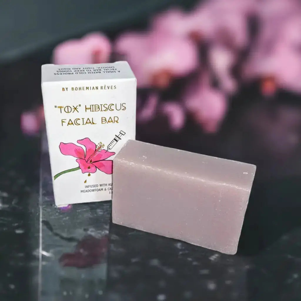 hibiscus contouring facial cleansing bar soap on a marble counter next to flowers