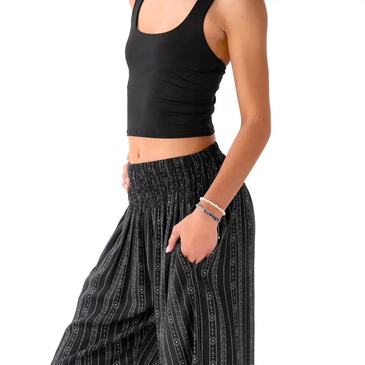 Close-up of Striped Black Boho Harem Pants with Pockets by Lotus and Luna, highlighting the smocked waistband and soft cotton fabric.