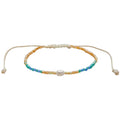 Lotus and Luna Make Waves Goddess Bracelet with white pearl in center surrounded by blue, green and gold crystal beads