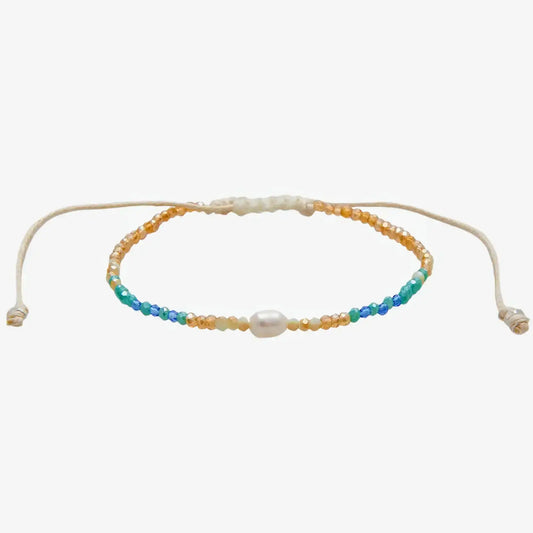 Lotus and Luna  "Make Waves" Goddess Bracelet with white pearl in center surrounded by blue, green and gold crystal beads