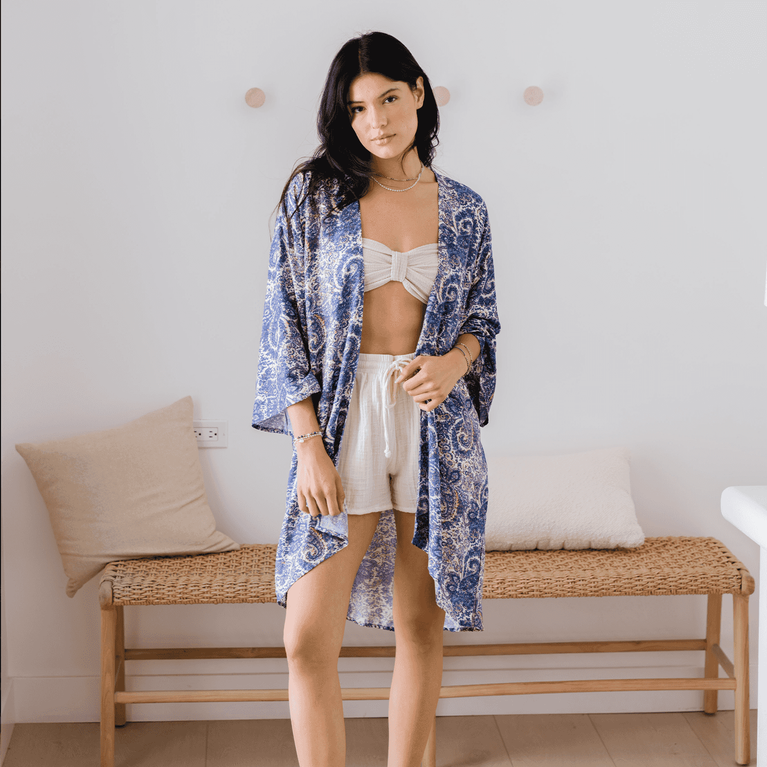 Lotus and Luna Beach Cover in blue paisley print, lightweight handmade swim wrap with side slits, worn over a bikini and shorts indoors.