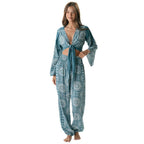 Woman wearing a blue patterned flare sleeve top from Lotus and Luna with matching Lotus and Luna Harem Pants.