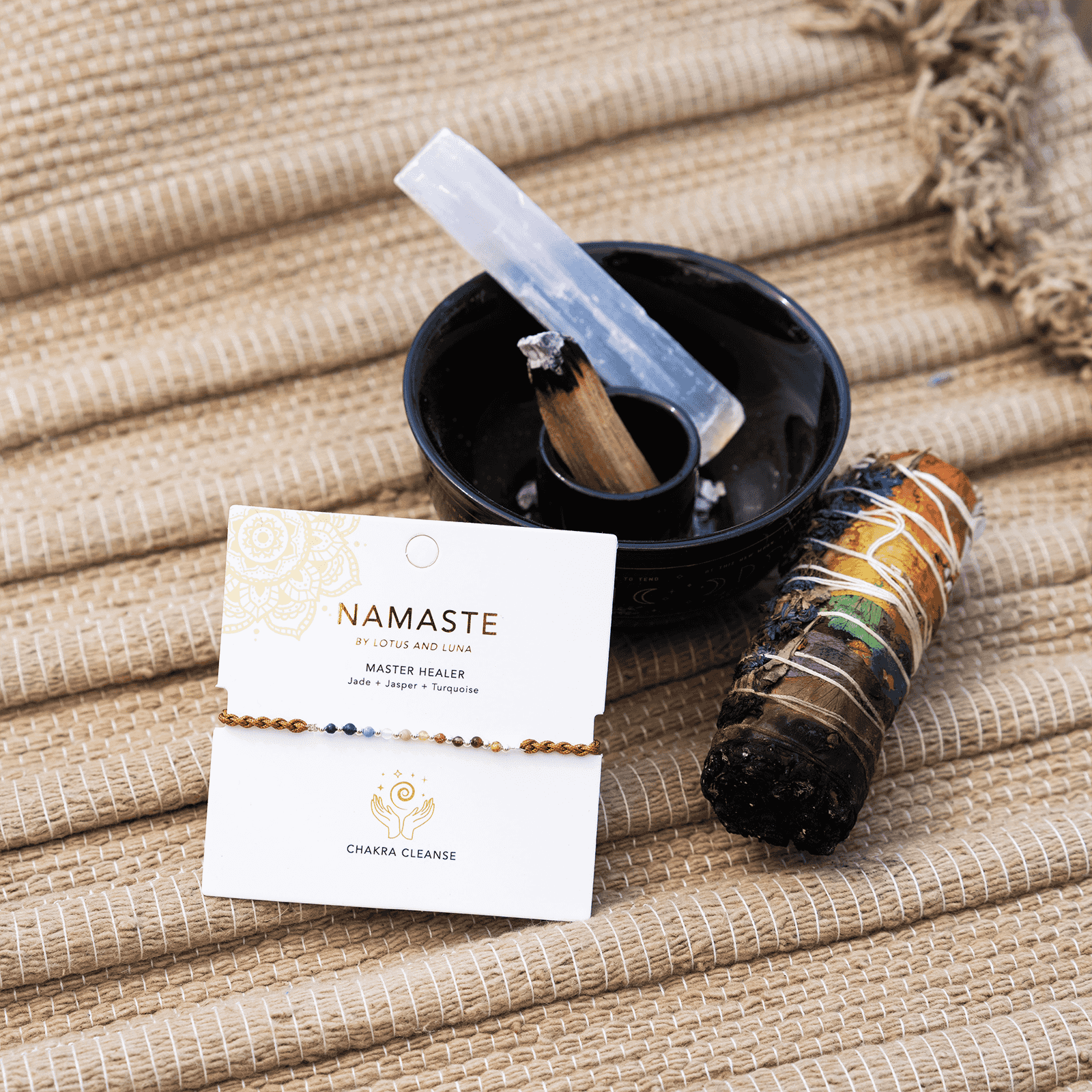 Master Healer Namaste Bracelet Next to Sage Stick and Quartz Crystal