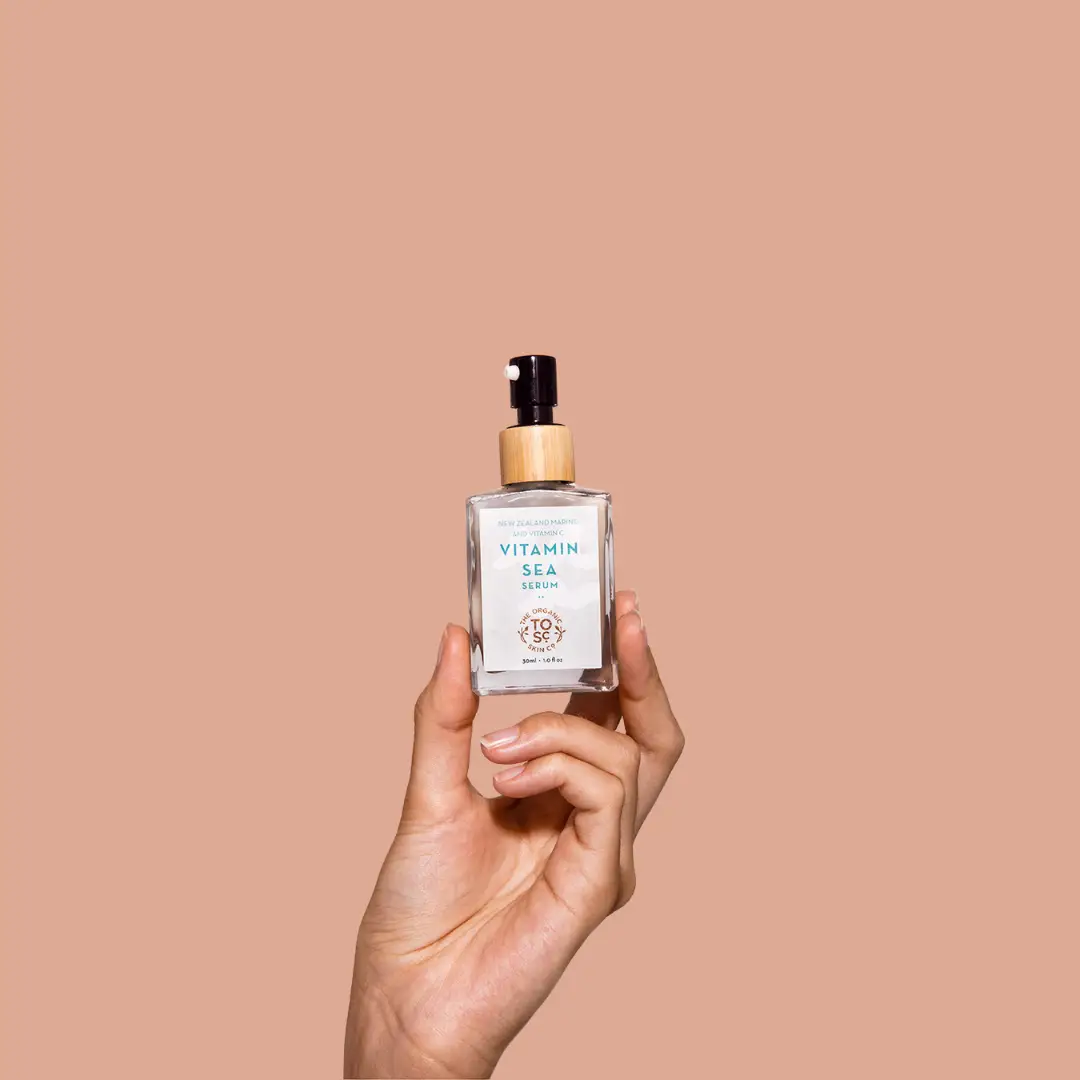 a hand holding up a bottle of Organic Skin Co Vitamin Sea, Vitamin C face serum 
