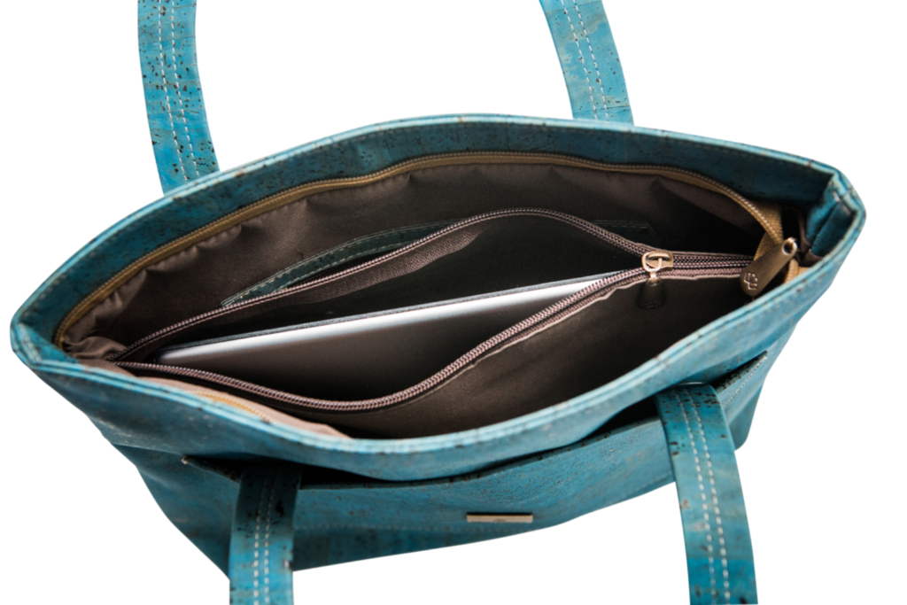 Grace Peacock Blue Handbag open top view with laptop inside, highlighting spacious interior and secure zippered section.