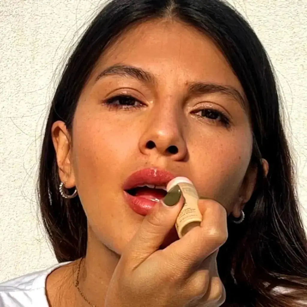 model applying pomegranate red lip stain