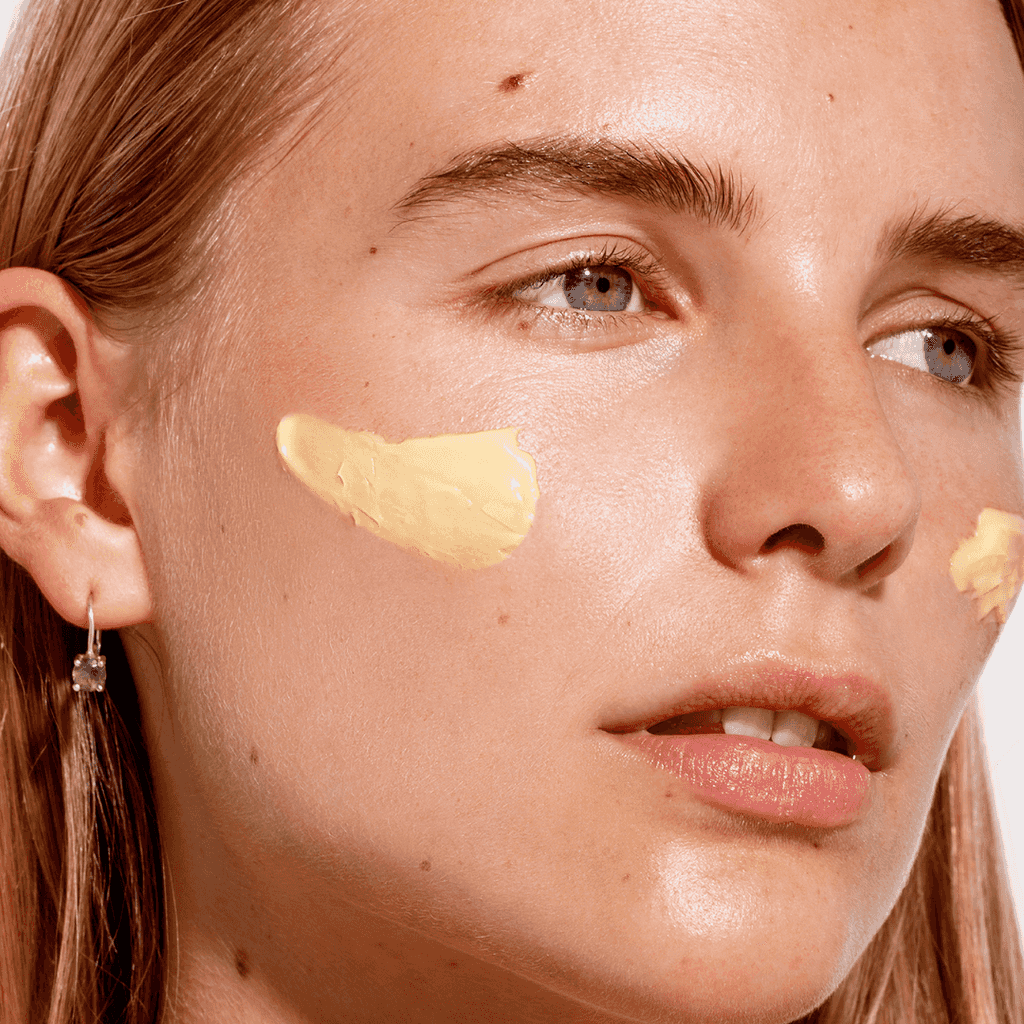 a woman with task force nine Calming Cream applied to face