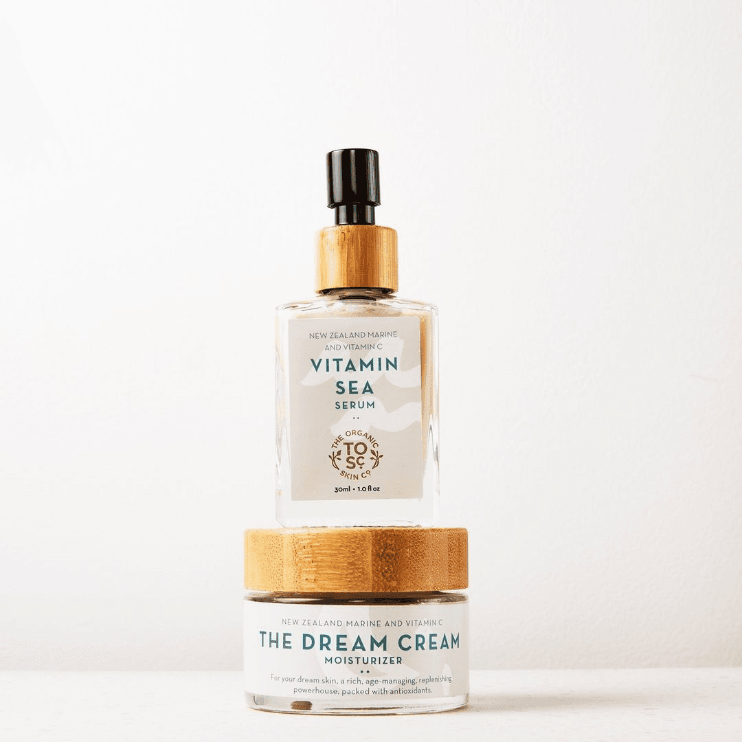a bottle of vitamin sea cream next to a container of dream cream