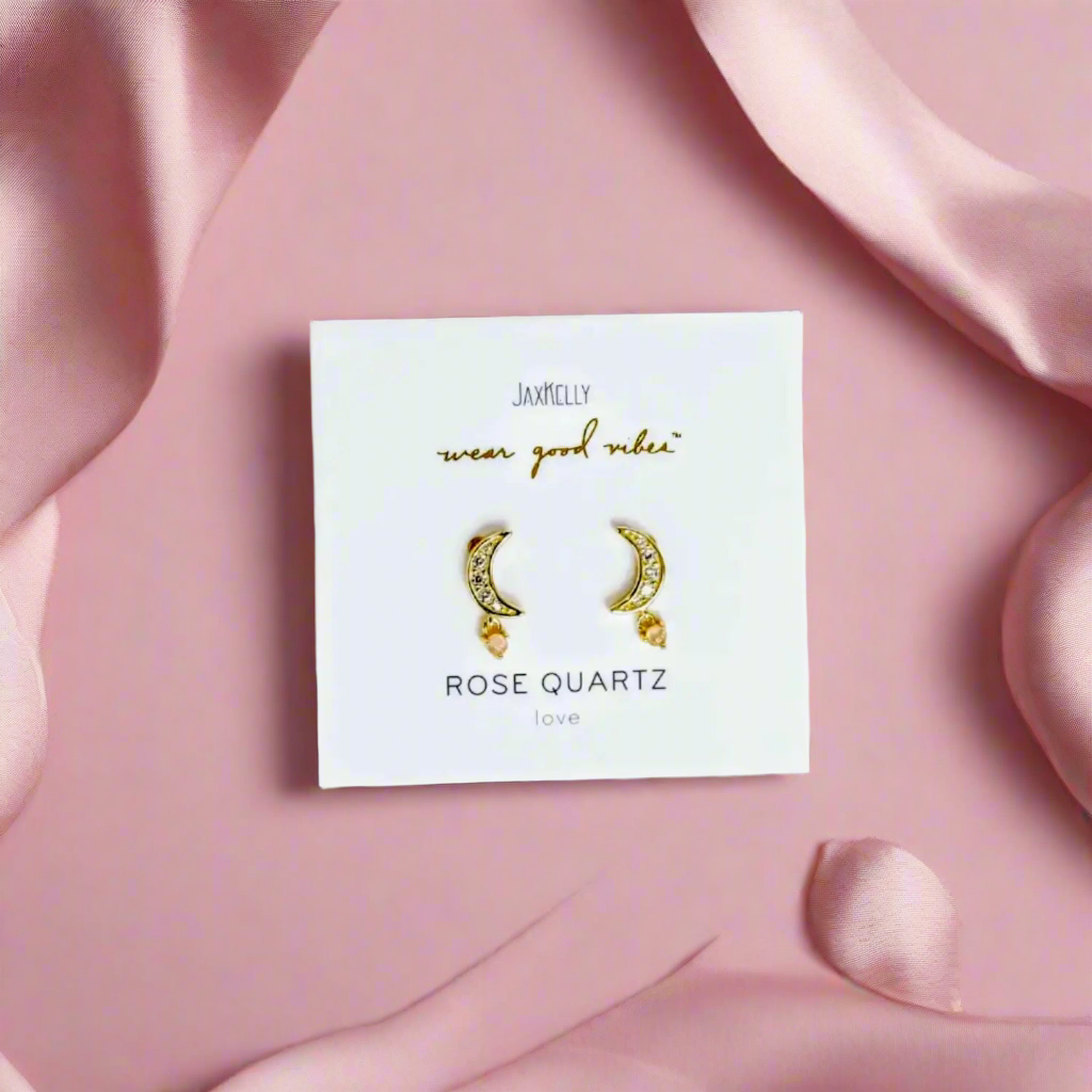 Rose quartz and yellow gold Moon earrings on a pink satin background