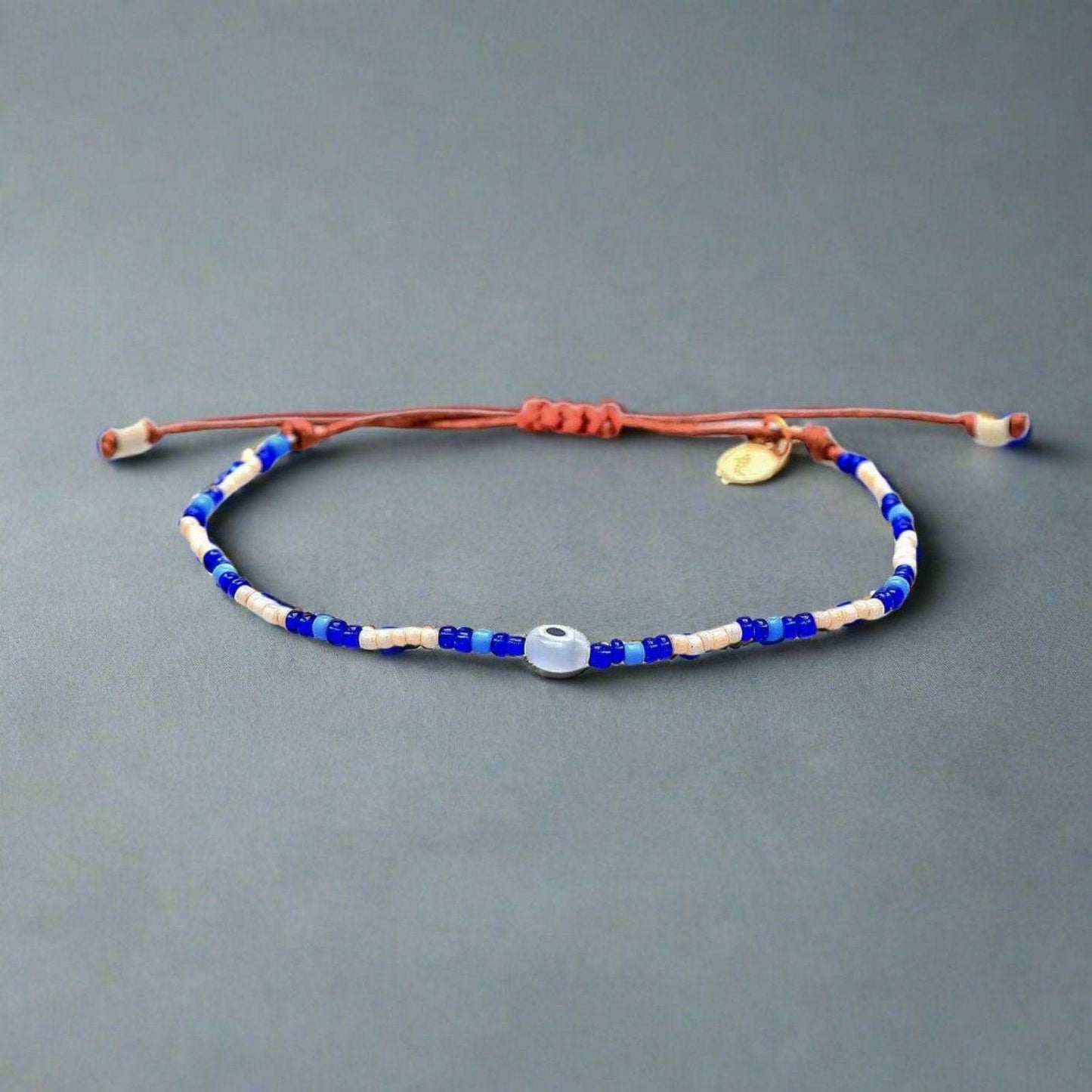 an evil eye beaded bracelet on an adjustable slider cord