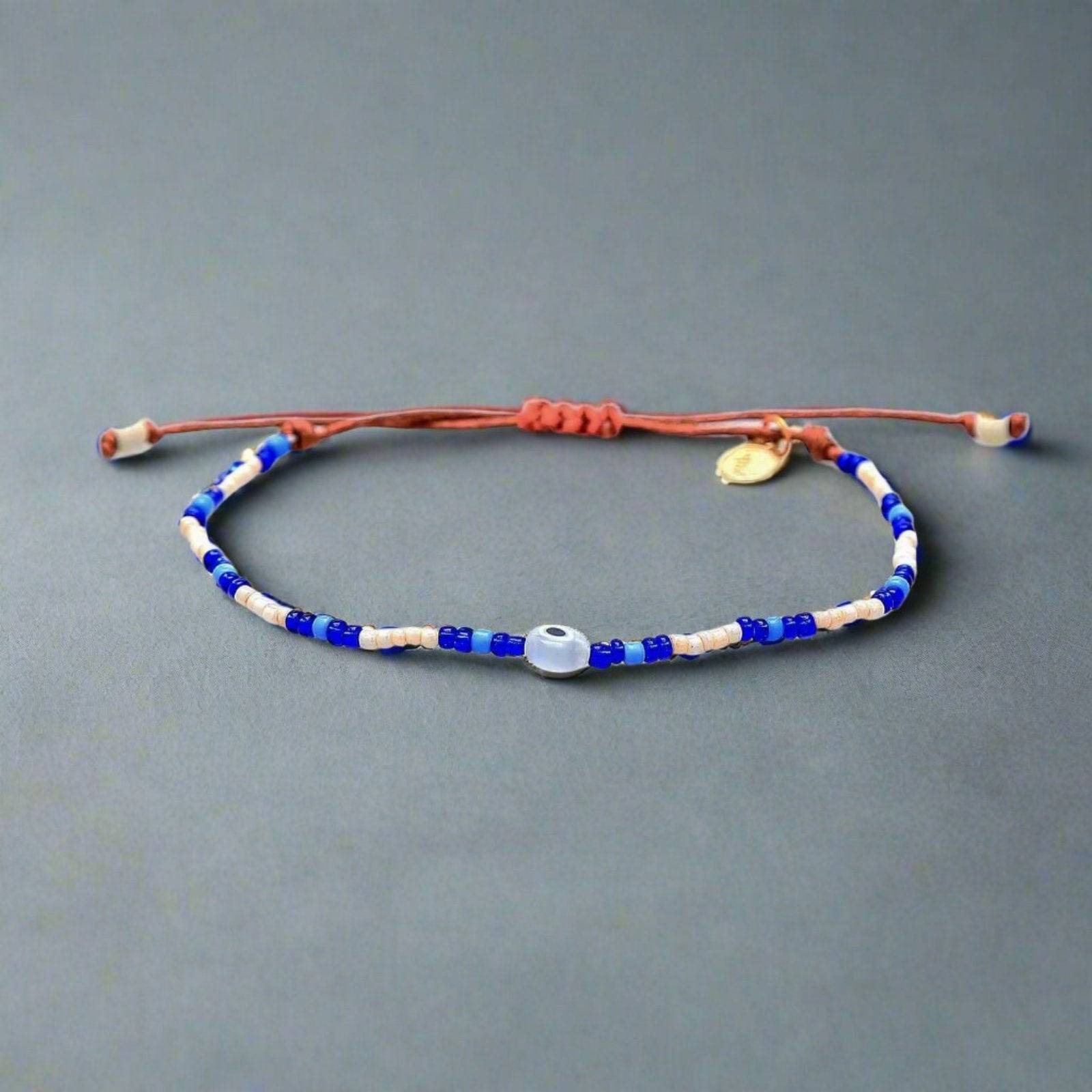 an evil eye beaded bracelet on an adjustable slider cord