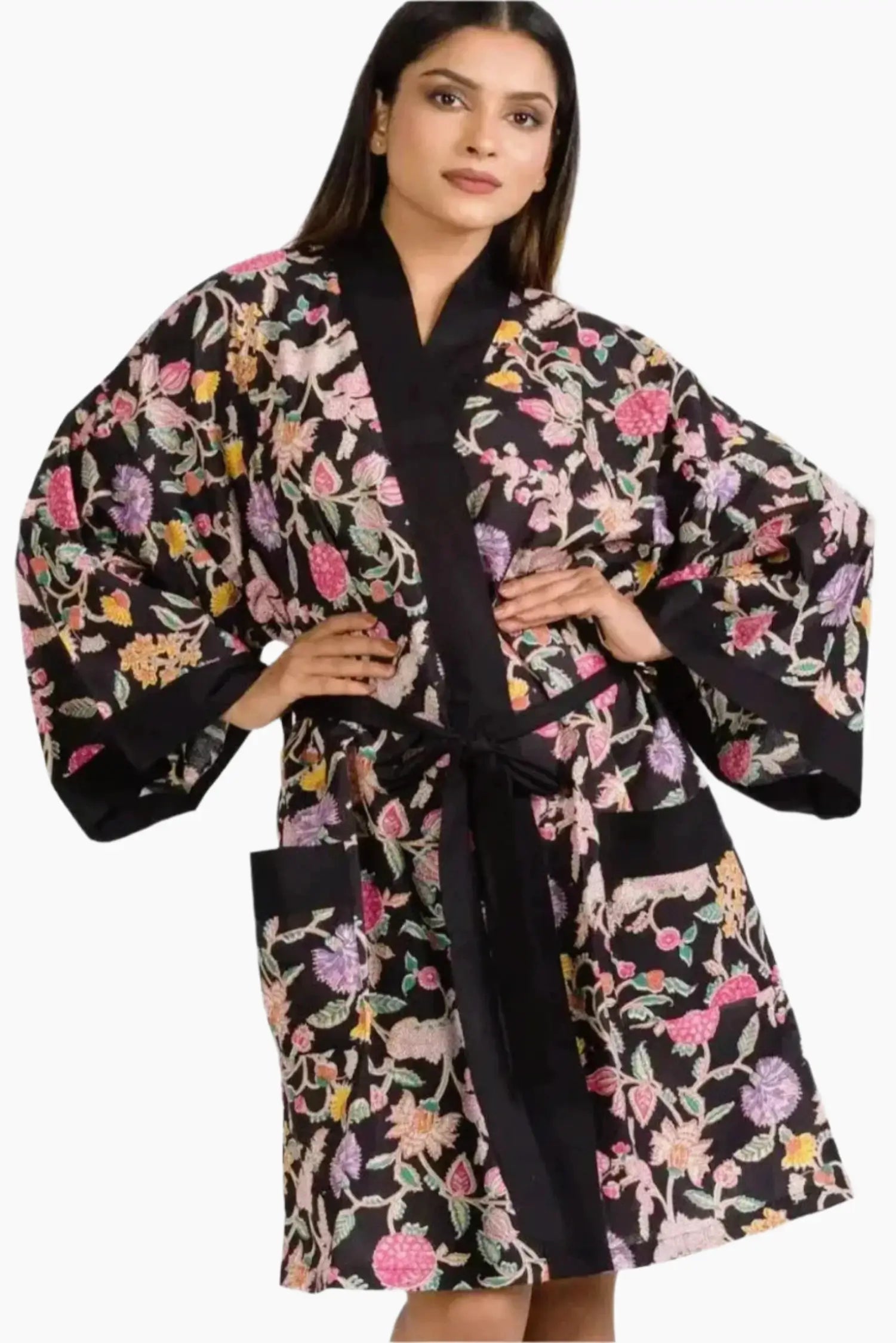 woman wearing a black robe with a floral print with contrasting black belt and pockets