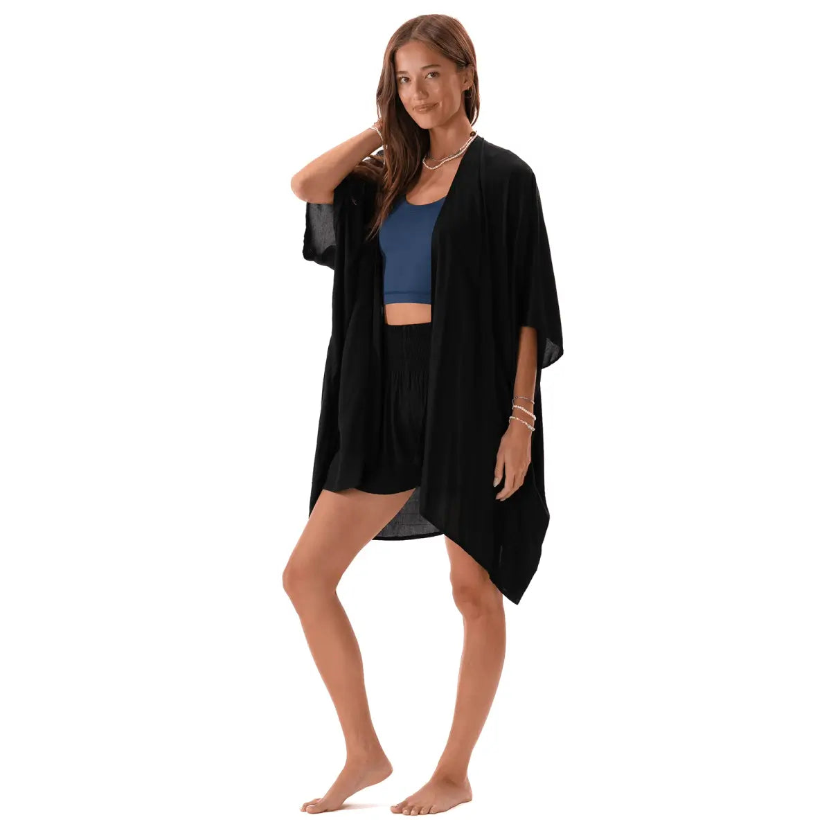 Woman wearing a black kimono-style cover-up by Lotus and Luna