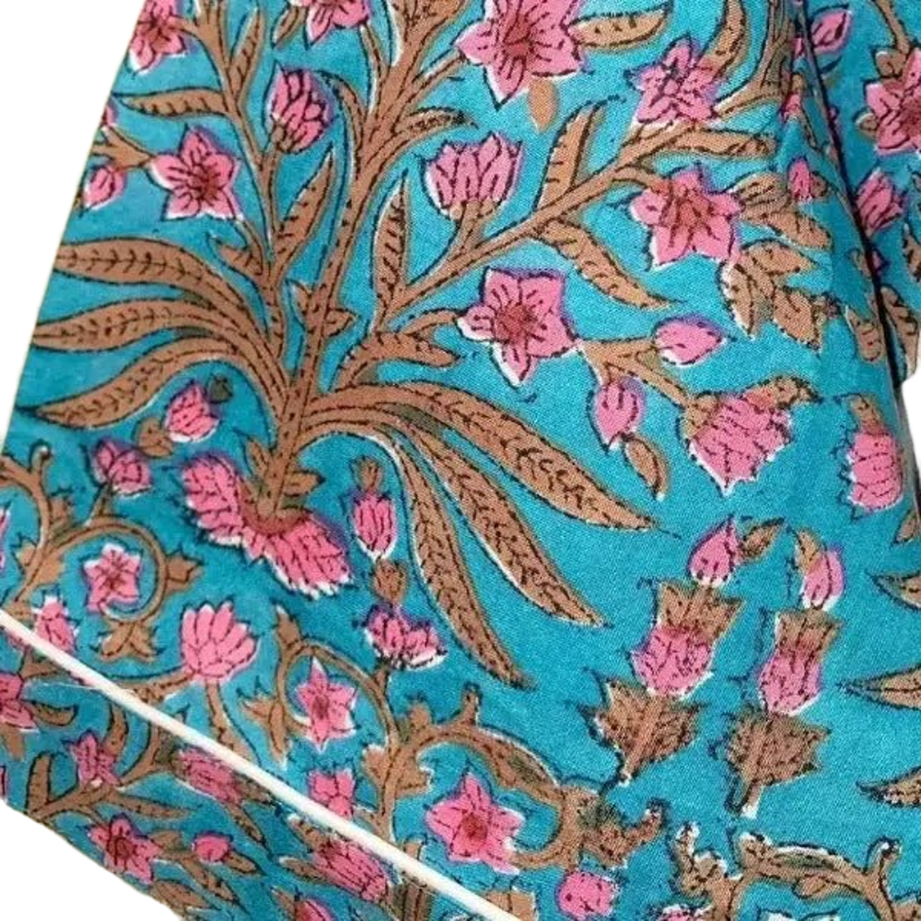 Blue Floral patterned fabric with pink flowers and brown leaves on a blue background