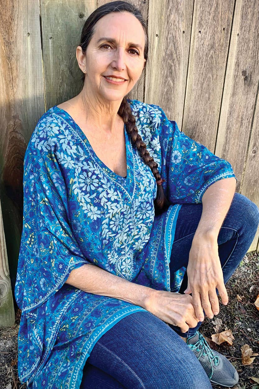 blue floral embroidered tunic boho top back view on model wearing jeans