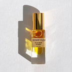 Bohemian Reves Desert Fleur Botanical Perfume Roll-on Fragrance in a cylindrical glass bottle with a gold colored cap