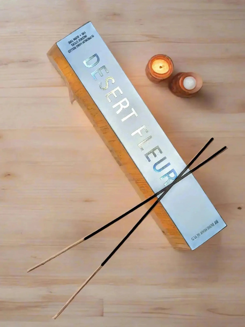 bohemian reves desert fleur incense sticks next to tea light candles