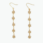 Boho flower earrings in 14k yellow gold with crystal accents, featuring five delicate floral drops for a chic, dangle style.