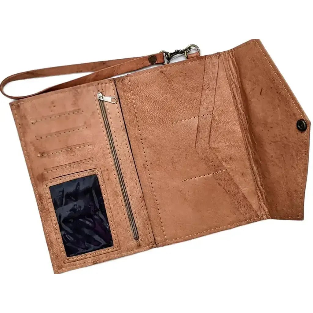 Brown leather clutch wallet with wrist strap, card pockets, clear id Holder and bill compartments on a white background
