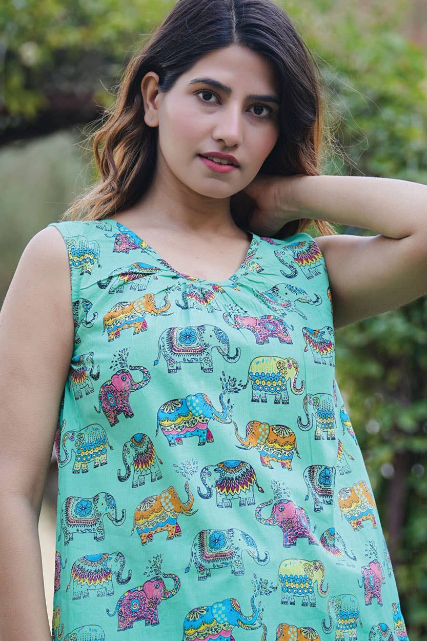 a woman in a tank top with elephants on it