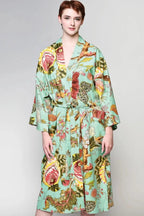 Woman wearing a green floral cotton kimono robe with long sleeves, a relaxed fit and long maxi length hemline.