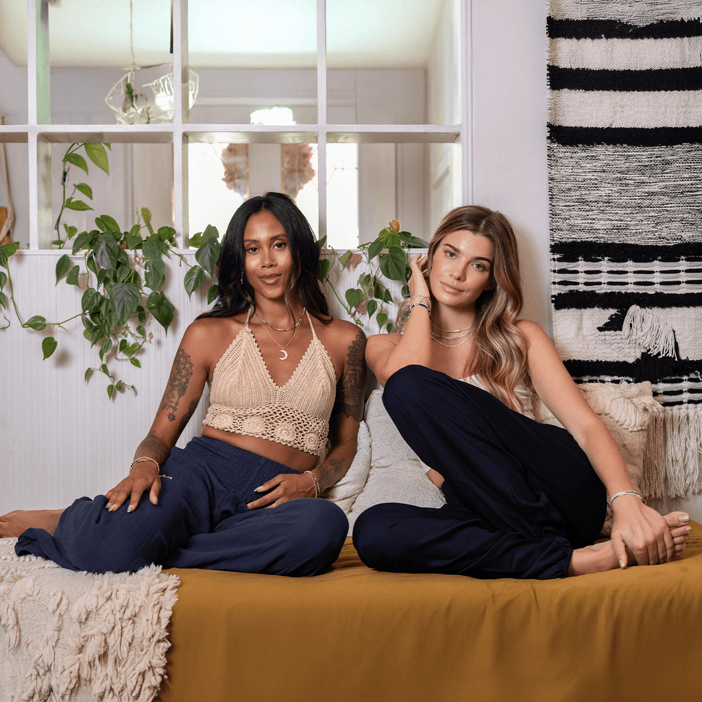 Women lounging in Lotus and Luna Harem Pants XL in navy, highlighting the pants' soft fabric and relaxed fit for cozy settings.